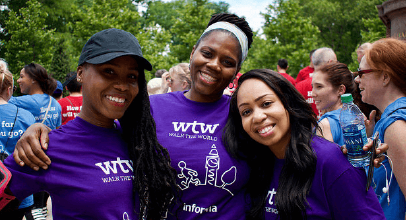 Three female Informa colleagues in purple Walk the World t-shirts at Informa's annual charity walk